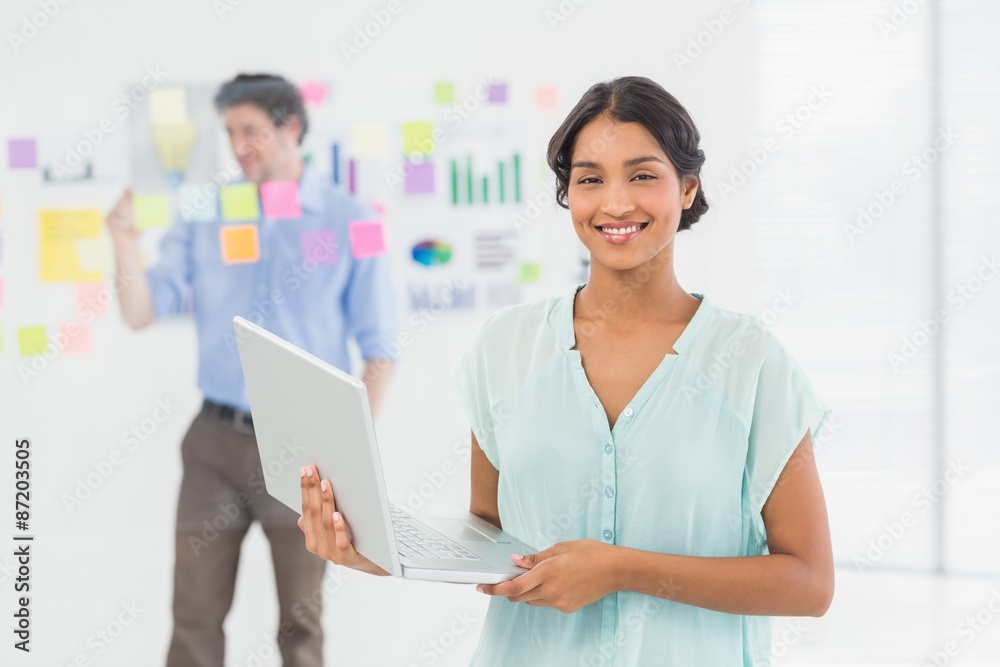 Smiling businesswoman presenting laptop screen Smiling businesswoman presenting laptop screen