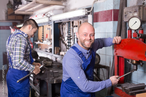 Men using tools in workshop © JackF