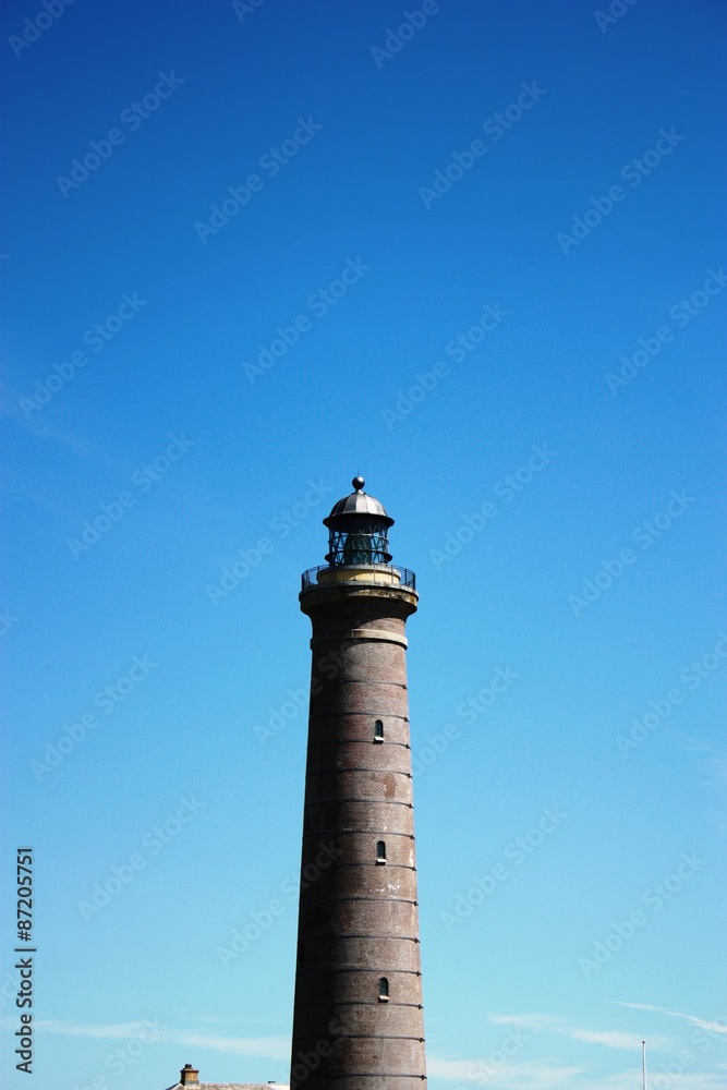 Skagen's Grey Lighthouse under blue sky, Denmark