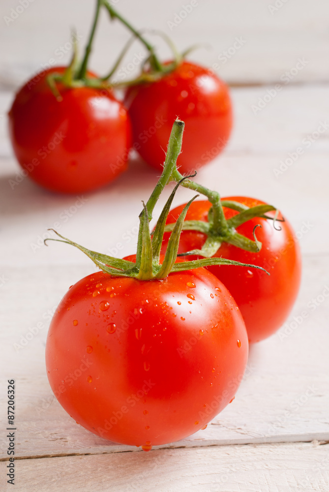 Fresh tomatoes on a wooden background Fresh tomatoes on a wooden background