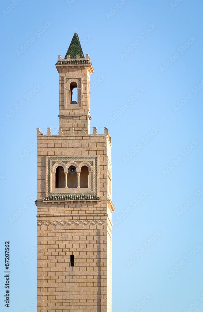 Minaret, Tunisia. Looking up at a traditional minaret tower, a distinctive architectural feature of mosques.