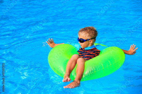 little boy having fun in the swimming pool