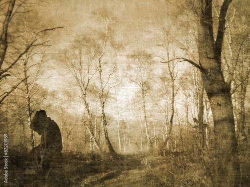 Monk figure praying in the forest