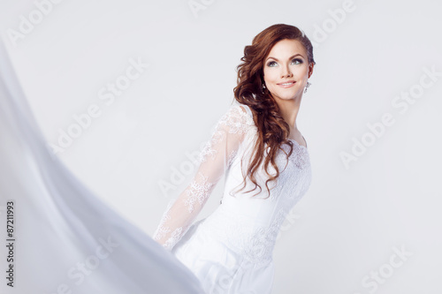 Beautiful bride in wedding dress, white background, close up