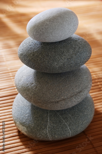 balanced stones on wooden background