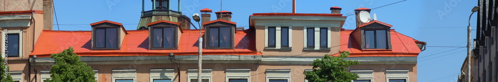 Red iron roof, dormers and chimneys