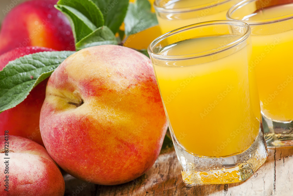 Fresh peach juice with fruits on a wooden background, selective Fresh peach juice with fruits on a wooden background, selective