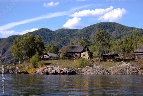 Rural wooden house in remote russian village. Little Yenisei river, Tuva, Russia.