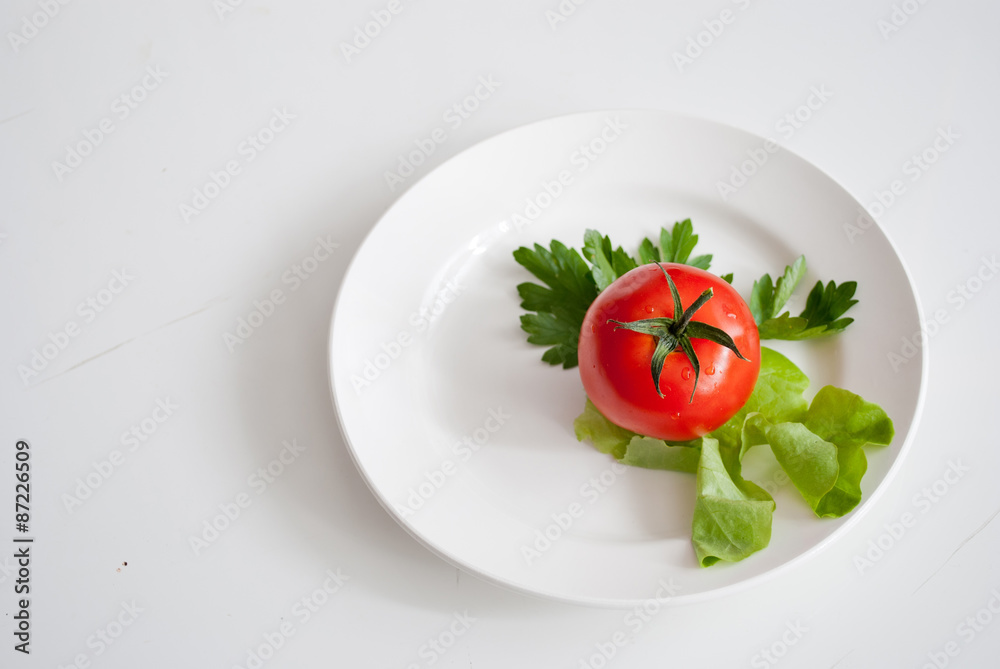 three tomatoes with salad on a plate three tomatoes with salad on a plate