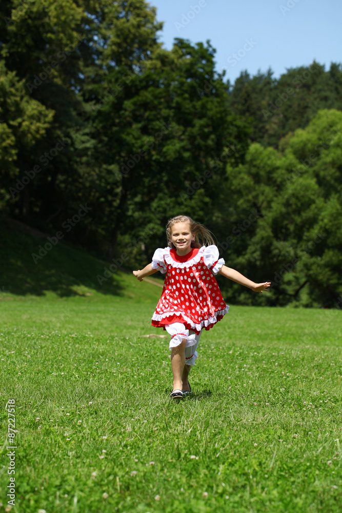 Little girl in a red polka-dot sundress into a major run on the Little girl in a red polka-dot sundress into a major run on the