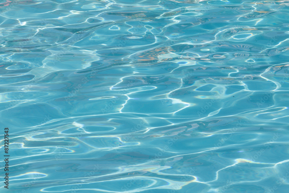 Blue pool water with sun reflections Blue pool water with sun reflections