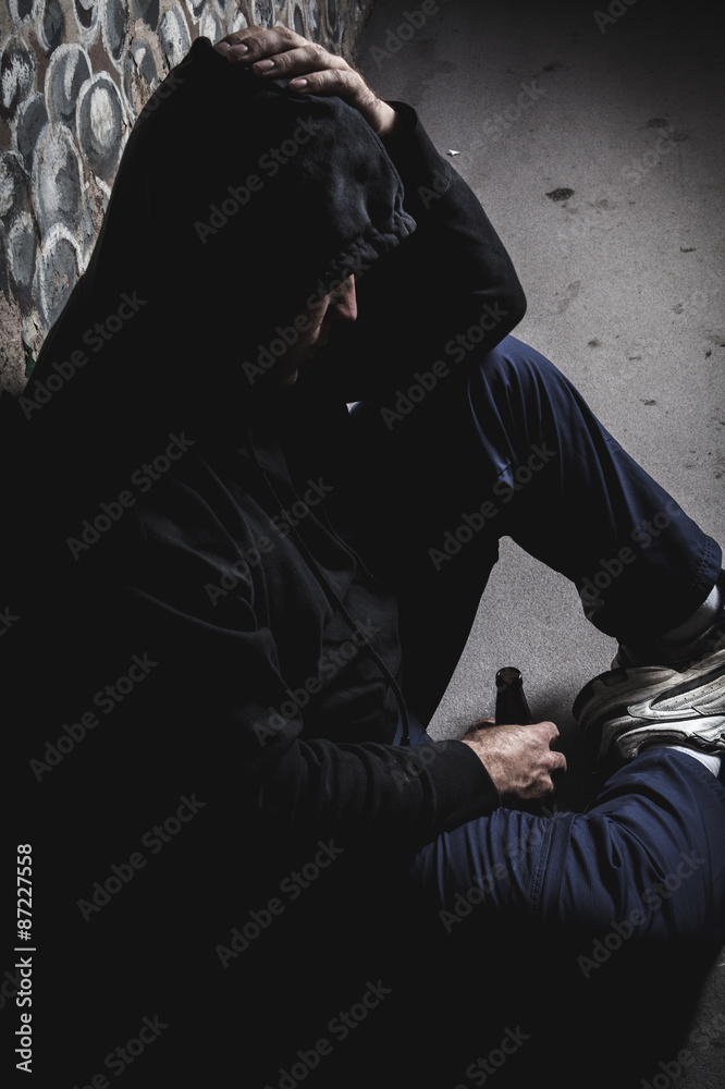 Young man abandoned lost in depression sitting Young man abandoned lost in depression sitting