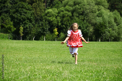 Little girl in a red polka-dot sundress into a major run on the