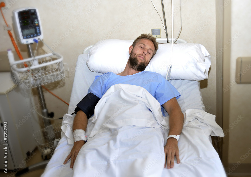 sick patient lying in bed hospital room resting from pain in bad health