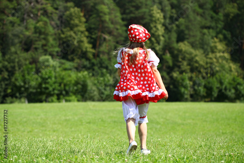 Little girl in a red polka-dot sundress into a major run on the