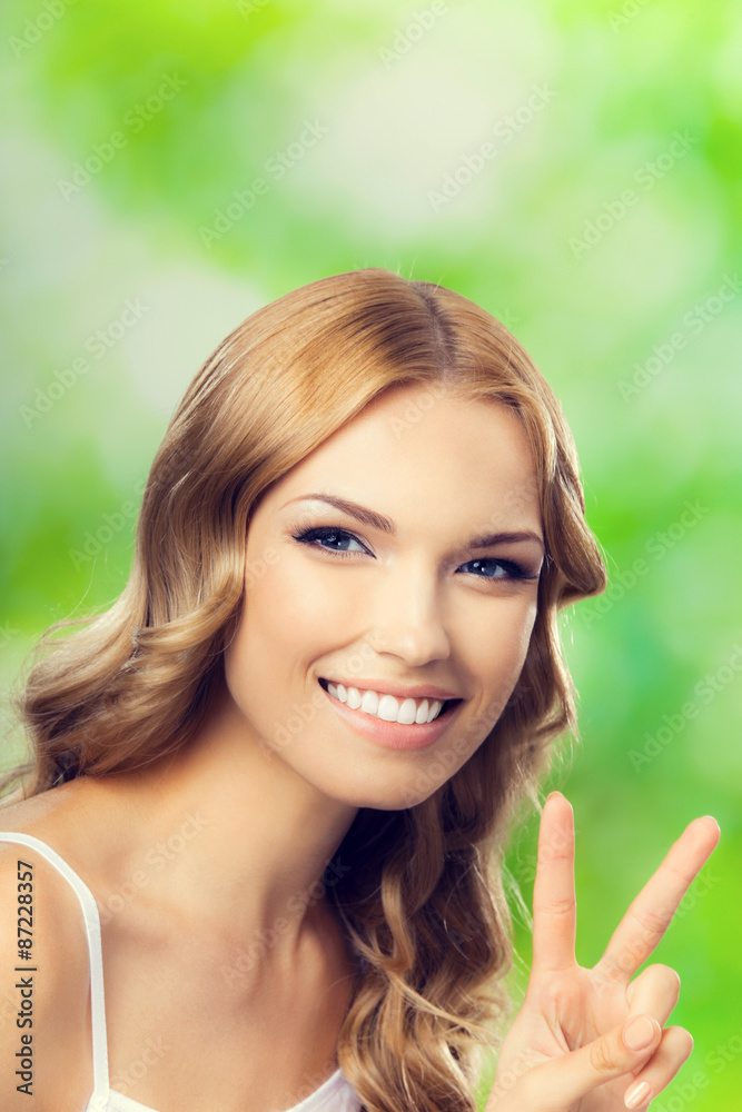 Young lovely woman, showing two fingers or victory gesture Young lovely woman, showing two fingers or victory gesture