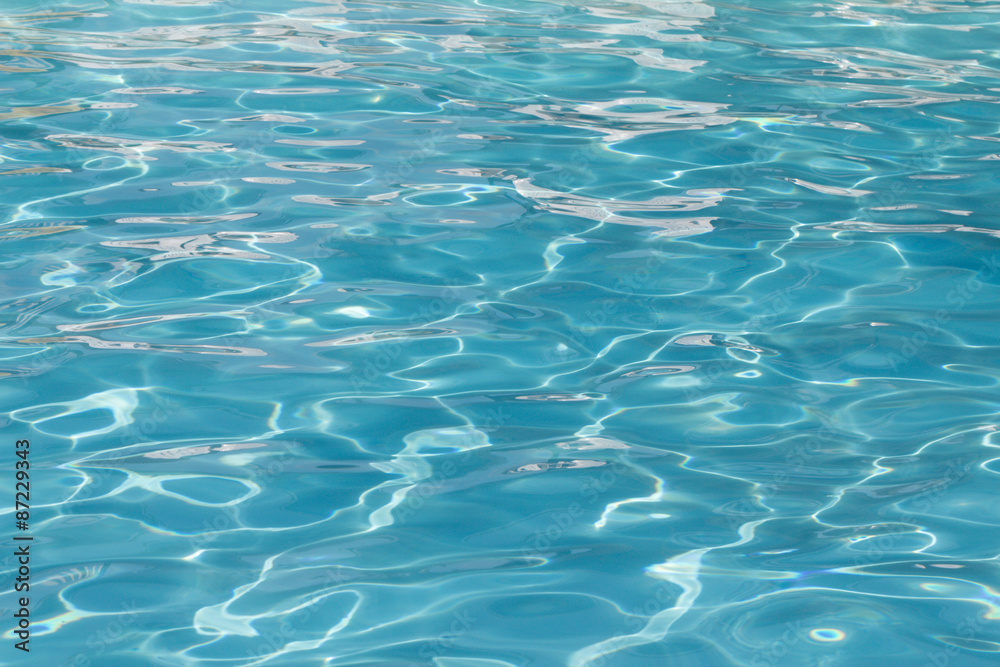 Blue pool water with sun reflections Blue pool water with sun reflections