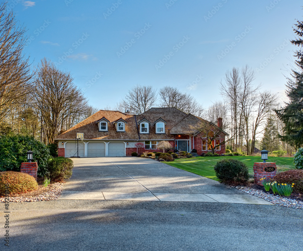 American traditional home with large driveway.