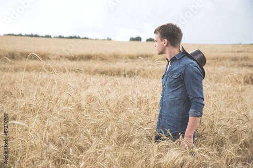 Young man standing in a field © Ruslan Mitin