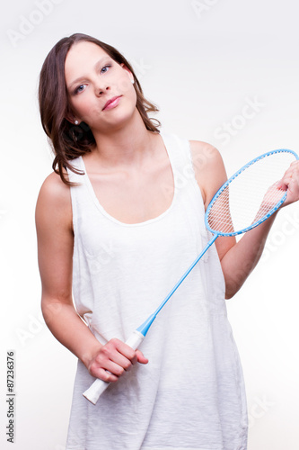 beautiful girl holding badminton racket - studio shot