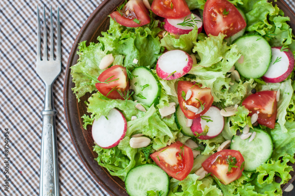 Tomato and cucumber salad with lettuce leafes Tomato and cucumber salad with lettuce leafes