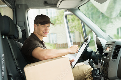 Happy Delivery Man Checking List © Andrey Popov