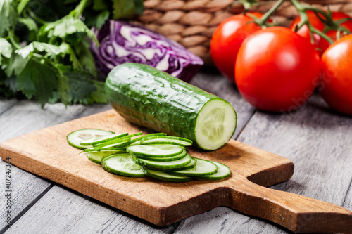 Chopped vegetables: cucumber on cutting board
