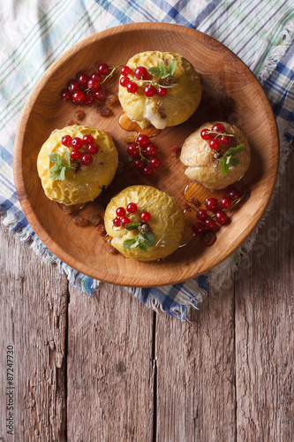 Rustic baked apples with honey and currant. vertical top view
