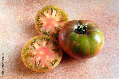 sliced cherokee purple tomato, an heirloom variety of tomatoes photo