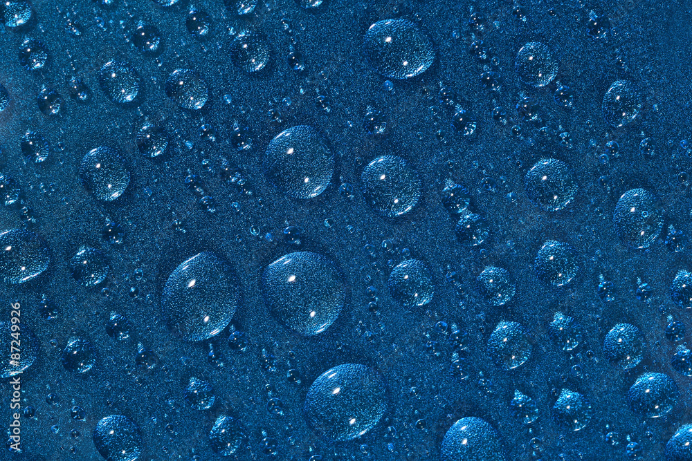 Water drops on the blue surface Water drops on the blue surface
