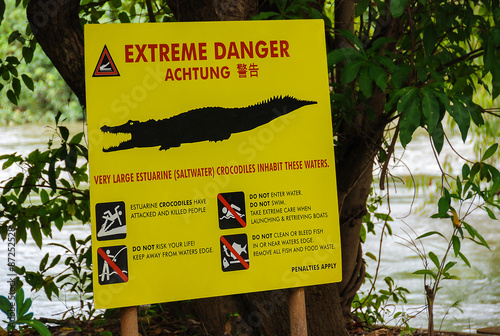 Crocodile warning sign Warning sign for very large estuarine (saltwater) crocodiles. Picture taken in Kakadu Nationalpark in Northern Territory, Australia.