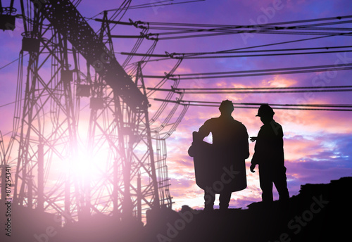Silhouette engineer looking work over Blurred substation