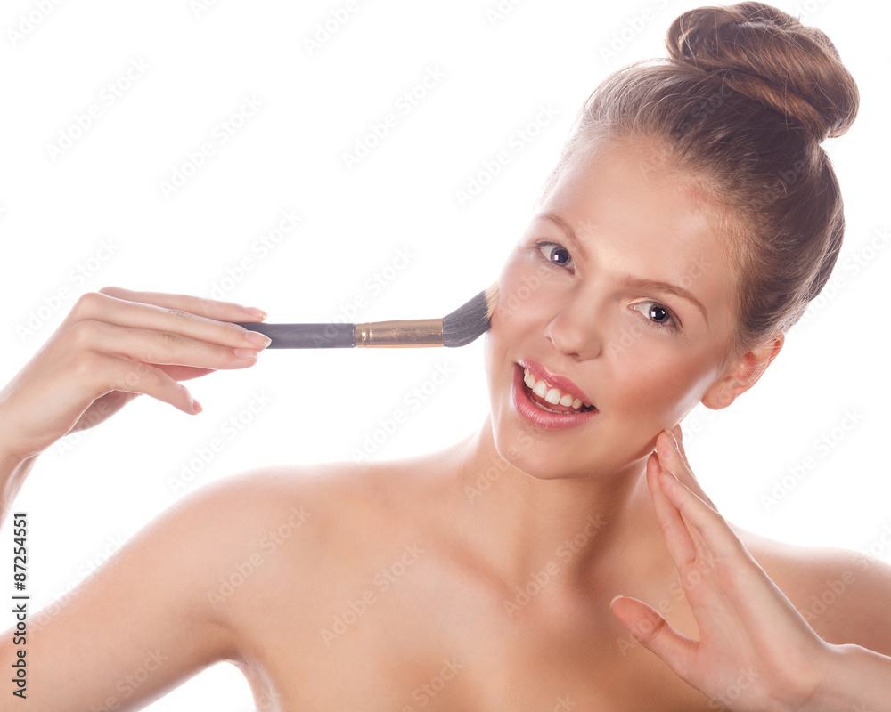 Girl with nude makeup holding makeup brush Girl with nude makeup holding makeup brush