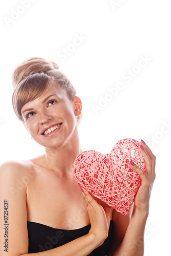 Girl with nude makeup smiling and holding heart. © Vagengeim