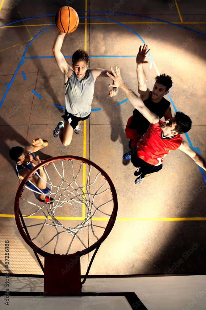 Naklejka premium young basketball players playing with energy