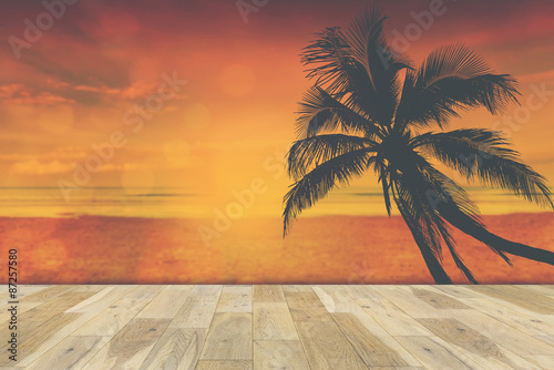 Wooden terrace with Coconut palms silhouette, Vintage color style.