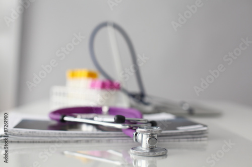 Pills  tablets and stethoscope on white background