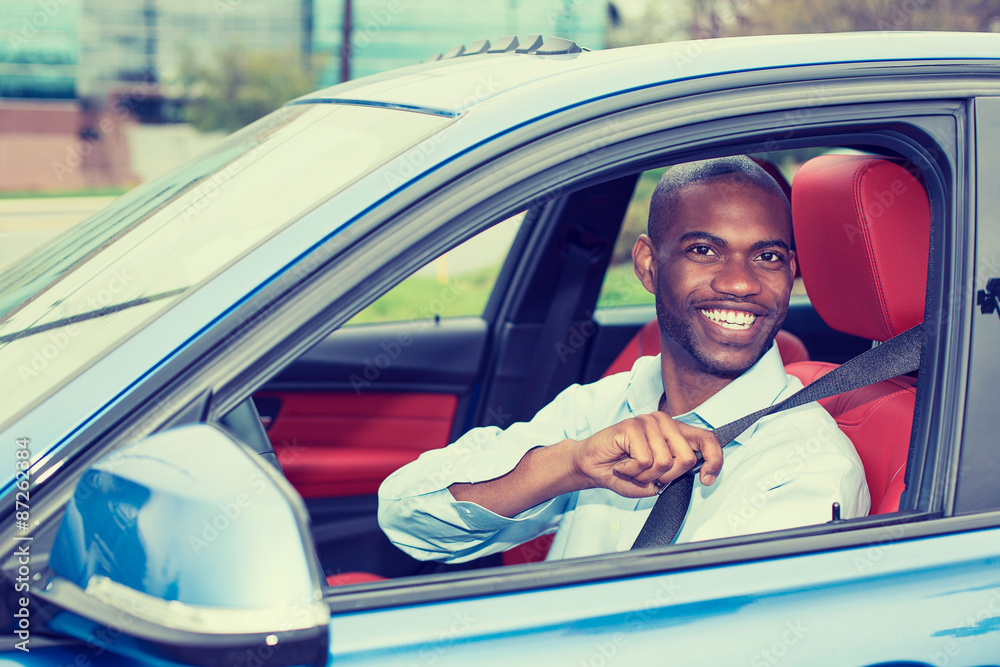 Naklejka premium Car driver young man wearing safety belt driving new car