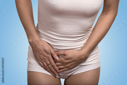 Wallpaper Mural  sick woman with hands holding pressing her crotch lower abdomen Torontodigital.ca