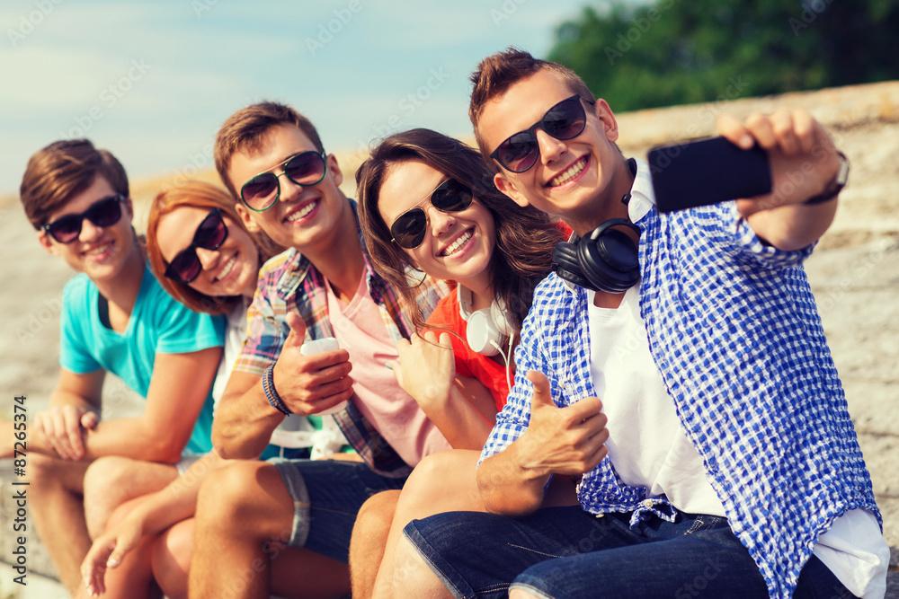 group of smiling friends with smartphone outdoors group of smiling friends with smartphone outdoors