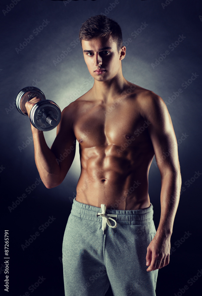 young man with dumbbell young man with dumbbell
