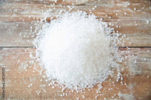 close up of white salt heap on wooden table