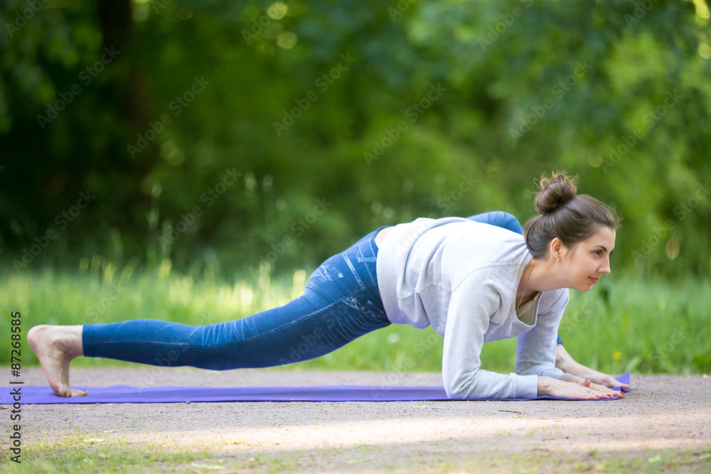 Lizard yoga pose in park alley