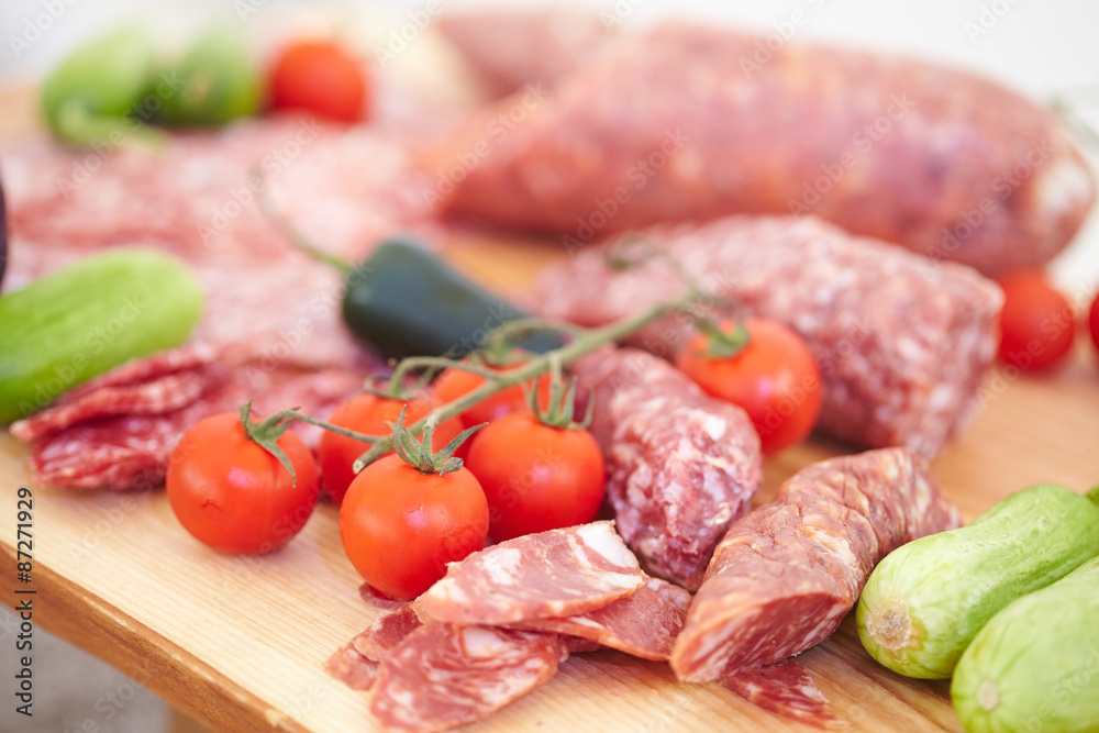 smoked meat products, vegetables on the table