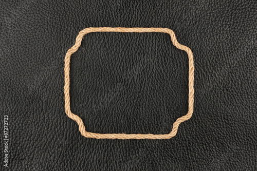 Figured frame made of rope lying on the natural leather