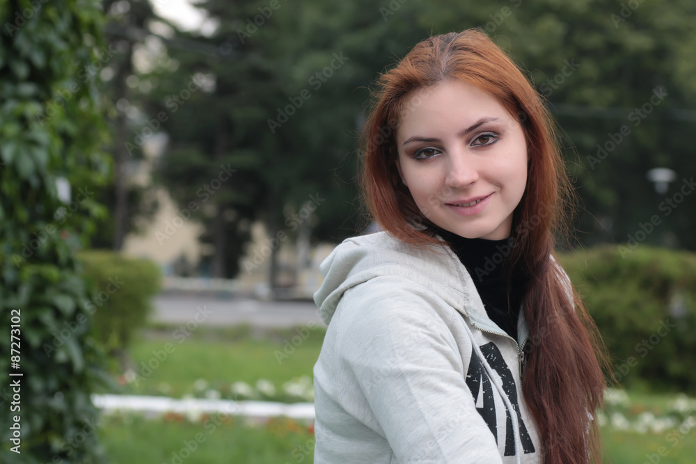 Portrait of red-haired girl in the park Portrait of red-haired girl in the park