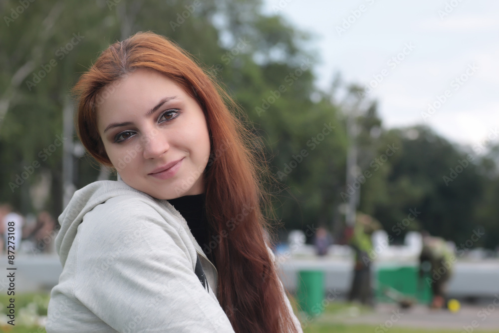 Portrait of red-haired girl in the park Portrait of red-haired girl in the park