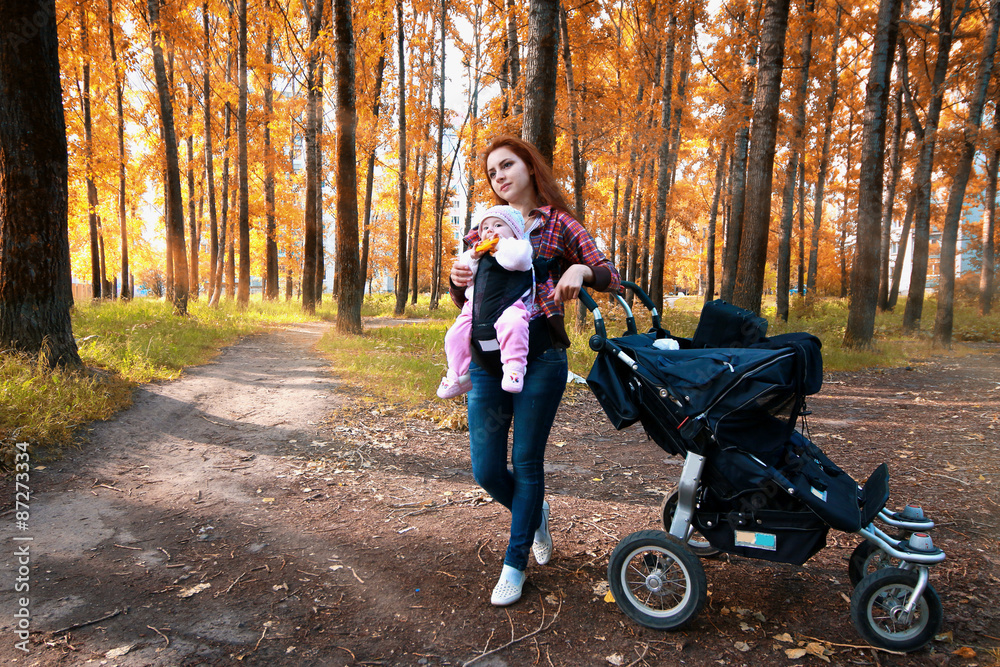 young family on a walk in the park sunshine young family on a walk in the park sunshine