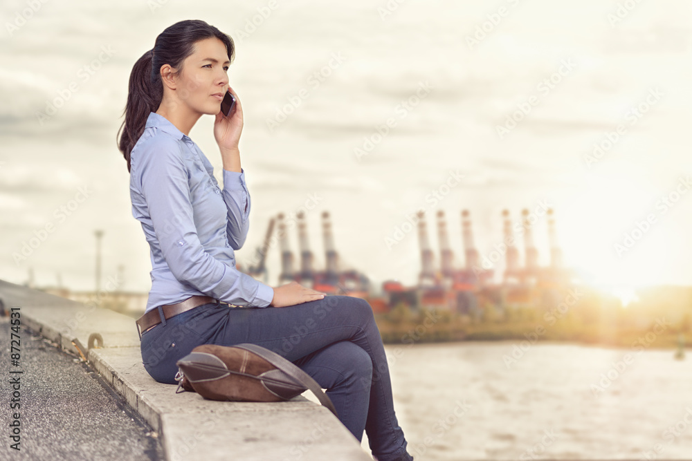 Attractive woman talking on her mobile phone Attractive woman talking on her mobile phone