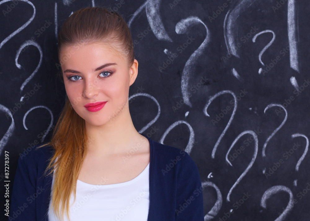 Young girl with question mark on a gray background Young girl with question mark on a gray background